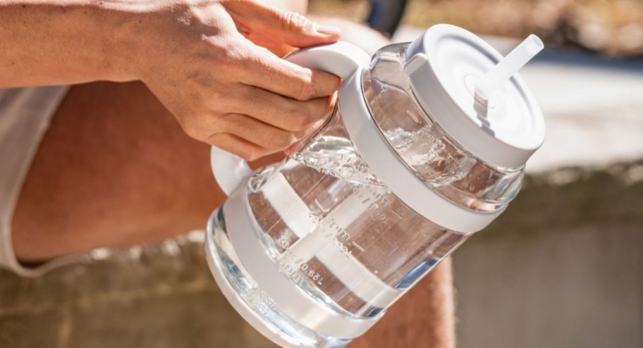 Hand holding HUGE jug of water