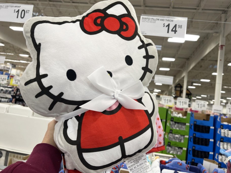 hand holding up a Hello Kitty Pillow and Throw Set