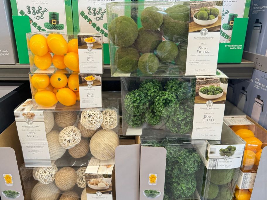A shelf full of Huntington Bowl Fillers like greenery and faux fruit