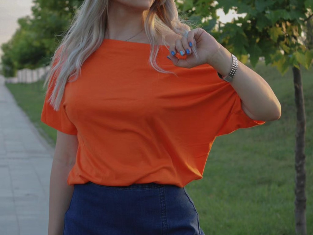 woman wearing orange off-shoulder shirt