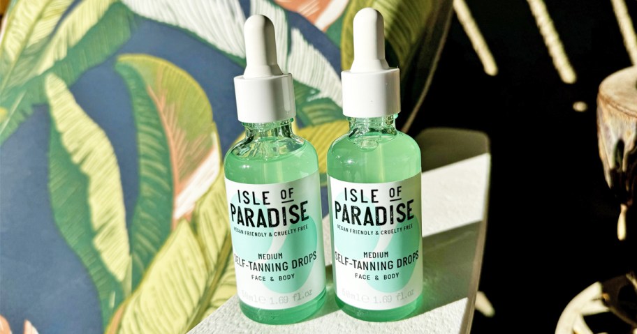 two green and white bottles of Isle of Paradise Self-Tanning Drops