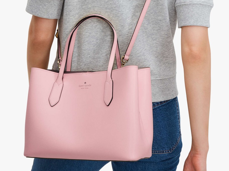woman in grey tee with pink kate spade satchel