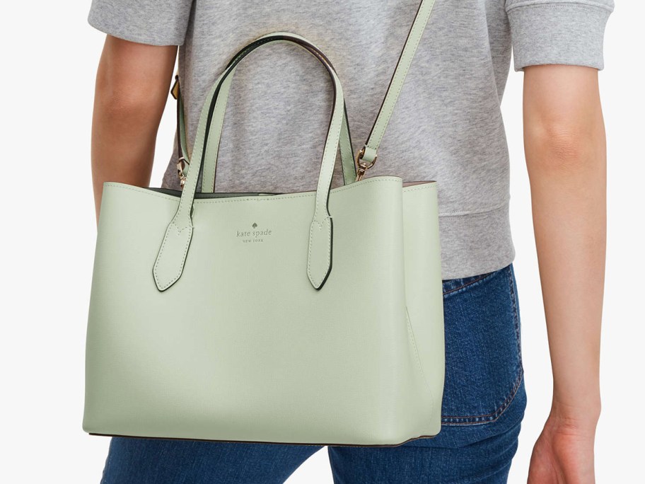 woman in grey tee with light green kate spade satchel