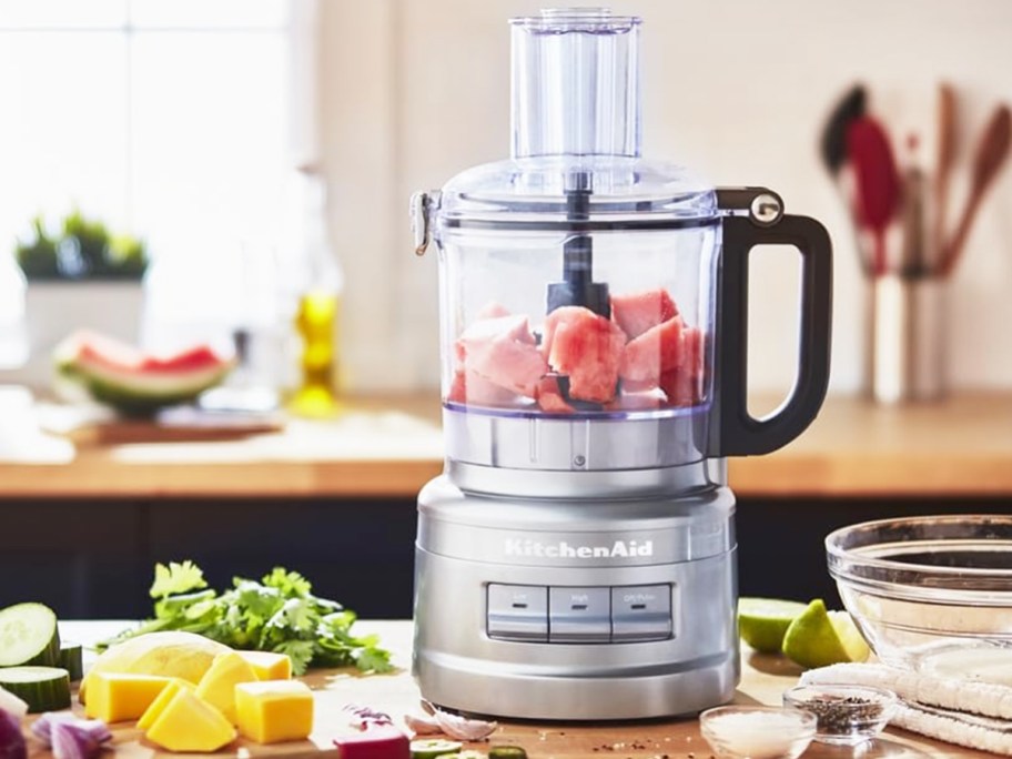 silver food processor with fruit inside