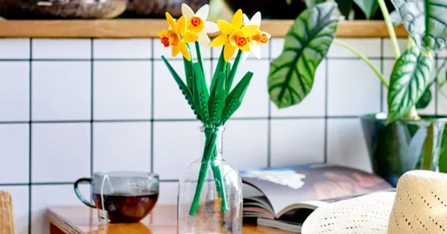 glass vase with 4 stems of yellow and white LEGO daffodils