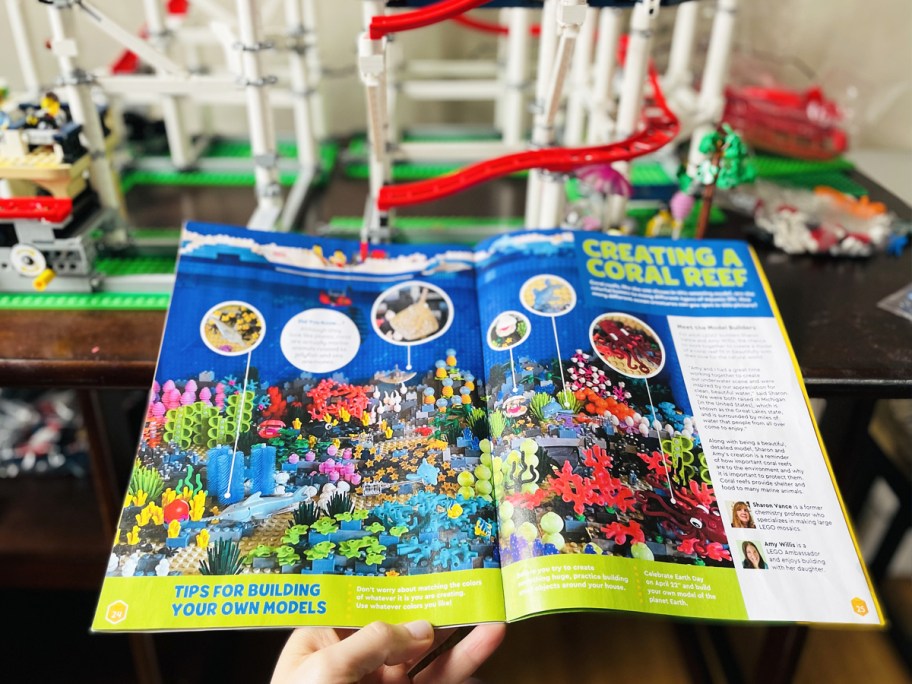 opened lego magazine in front of lego roller coaster