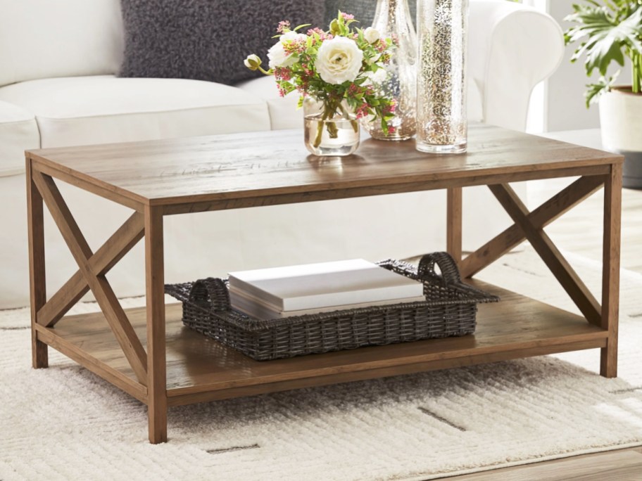 wood rectangular coffee table with vase of flowers on top