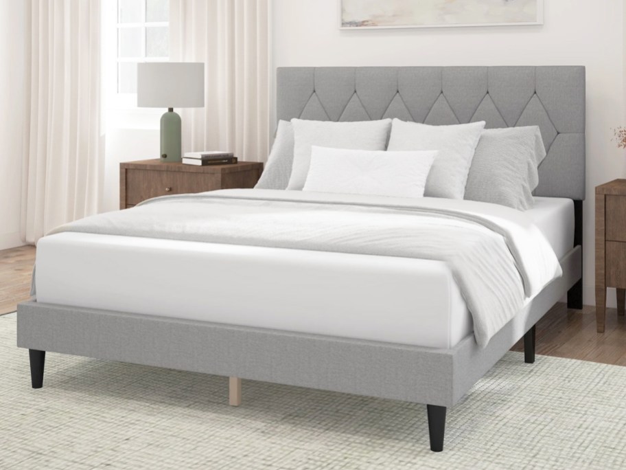 bed with a matching grey upholstered bed frame and headboard
