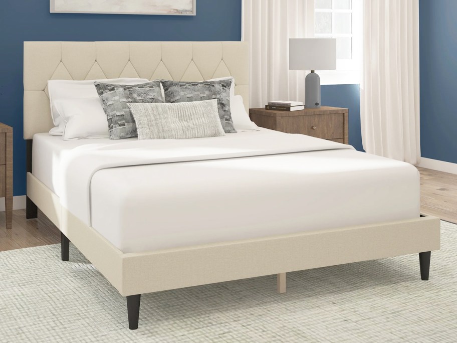 bed with a matching white upholstered bed frame and headboard