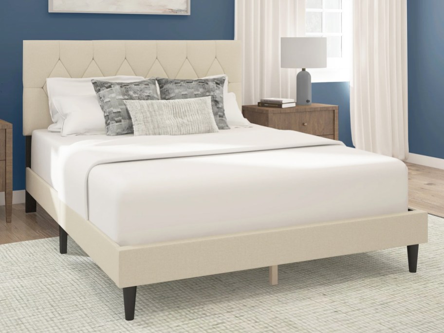 bed with a matching white upholstered bed frame and headboard