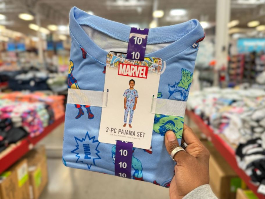 A hand holding a Marvel 2-piece Pajama Sets in Sam's Club 