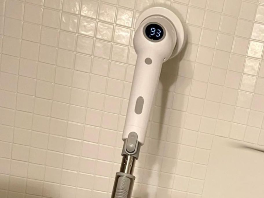 A maxdoria POwer Scrubber cleaning tile in a shower