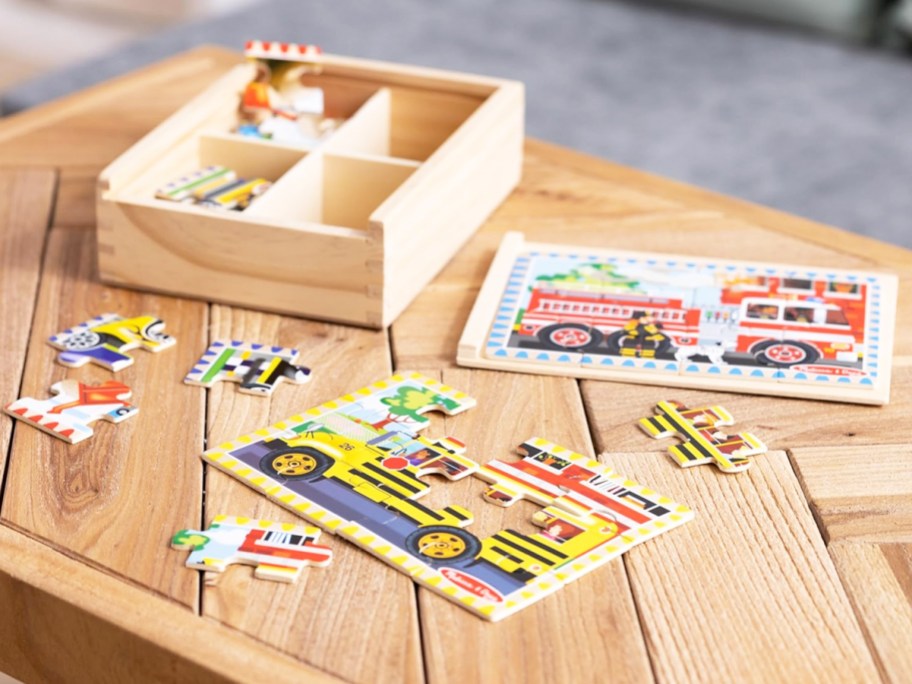 two wooden puzzles on table near wooden storage box