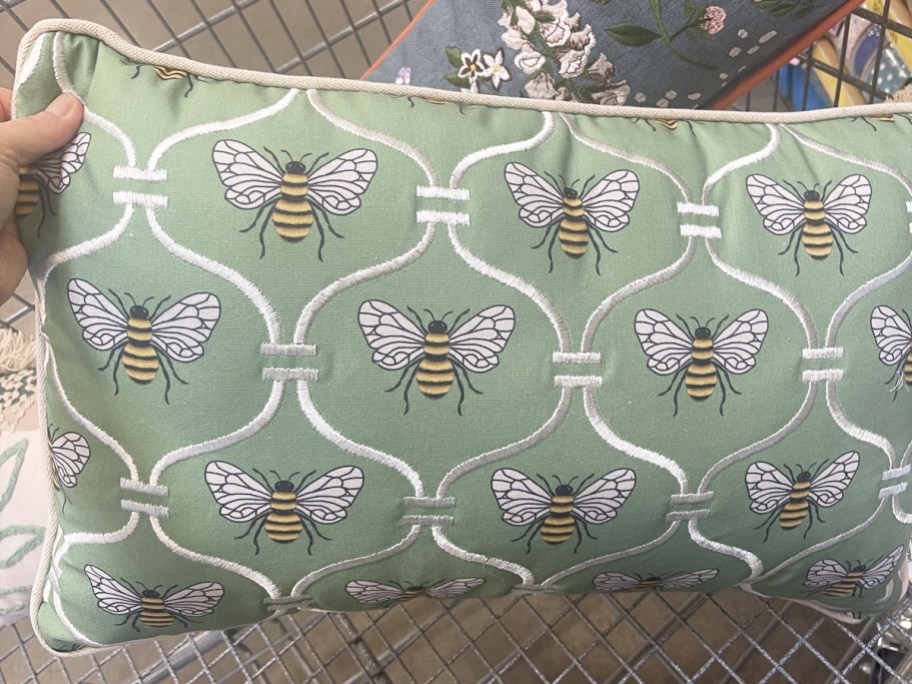 hand holding a bee print throw pillow