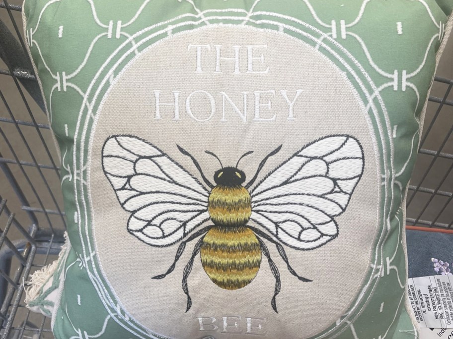 throw pillow that says "the honey bee" with a bee in the center