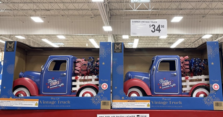 red and blue vintage metal trucks on store shelf