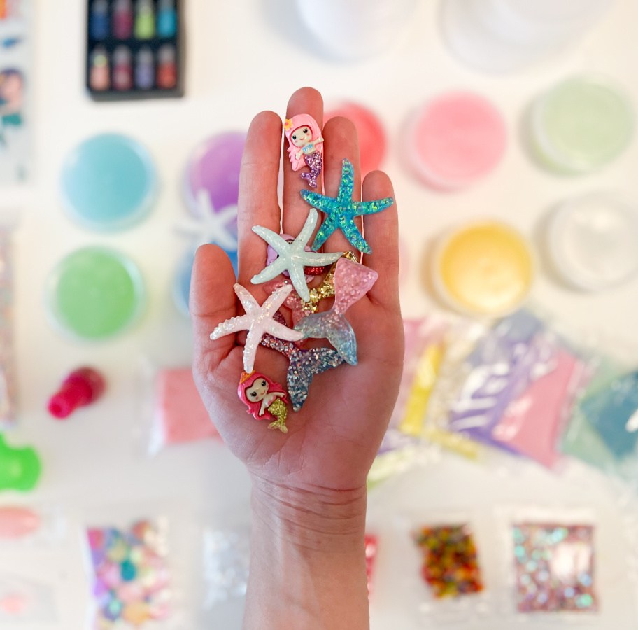 hand holding Mermaid themed beads for a slime kit