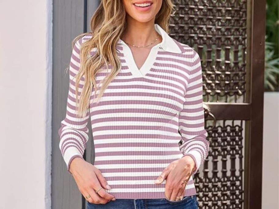 woman wearing a striped long-sleeve ribbed top with a color standing outside