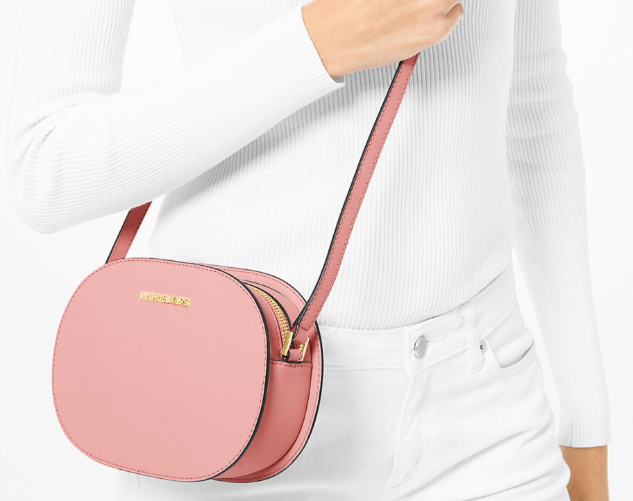 woman in white outfit with pink oval crossbody bag