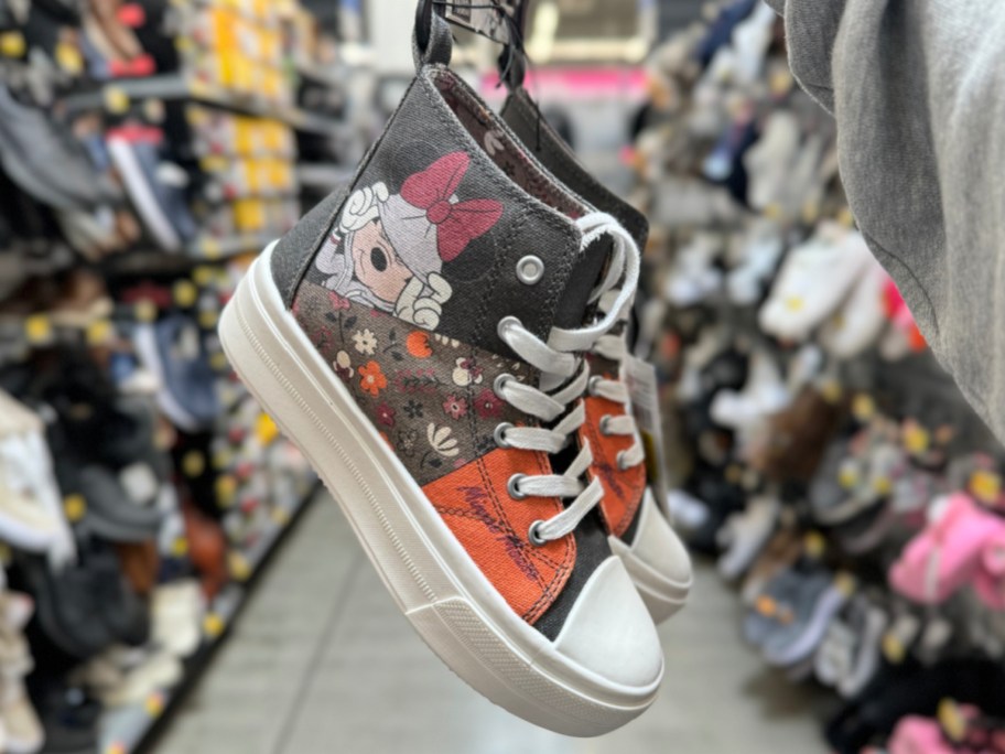 Minnie Mouse platform sneakers in woman's hand at the store