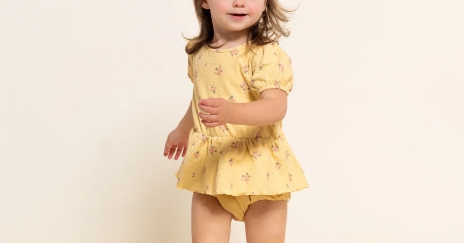 toddler girl wearing gerber baby modern moments yellow romper