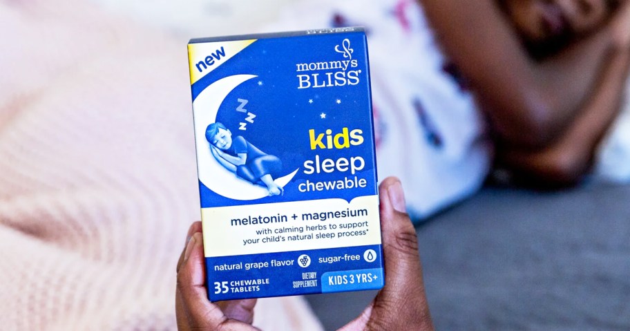 hand holding up a box of Mommy's Bliss Kids Sleep Chewable Tablets