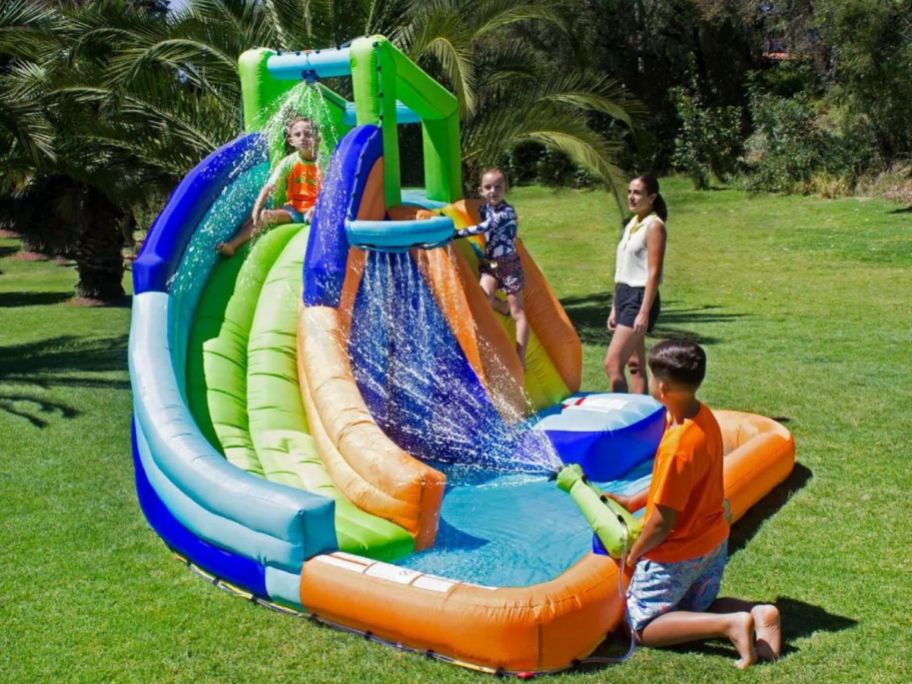 Kids playing with a My 1st Water Slide Splash and Slide with Tunnel