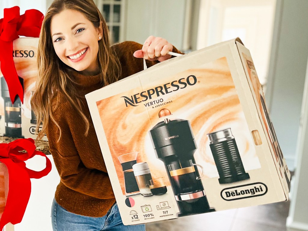woman holding up nespresso vertuo box in kitchen