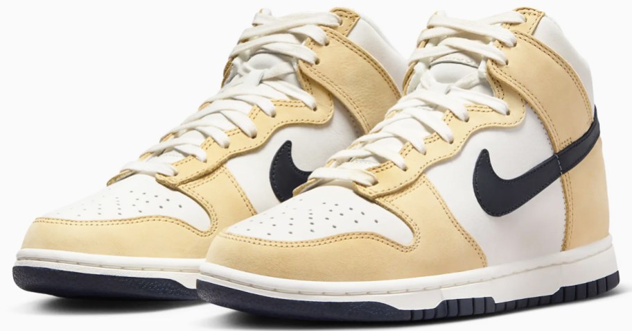 pair of tan, white, and black high top nike sneakers
