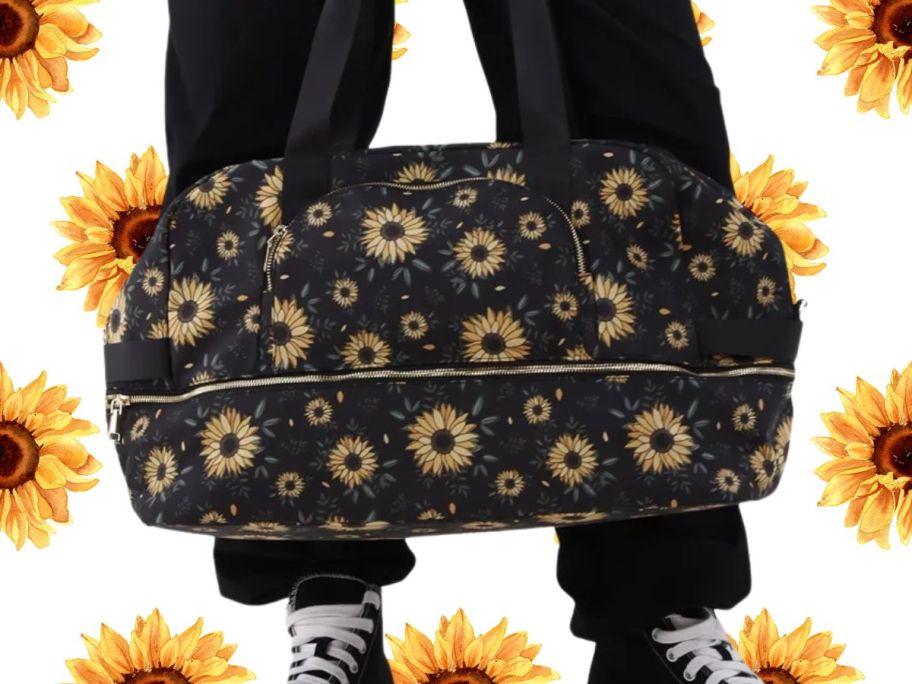 person holding No Boundaries Weekender Bag - Black Sunflower against sunflower patterned background