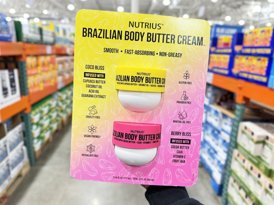hand holding a 2-pack of body butters