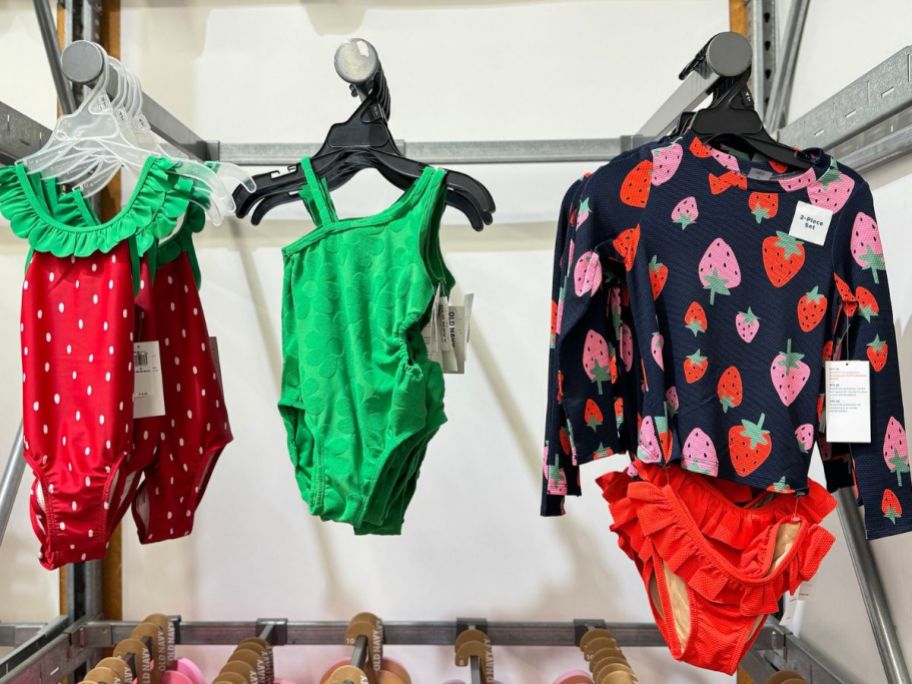 old navy baby girl strawberry swimsuits hanging on rack