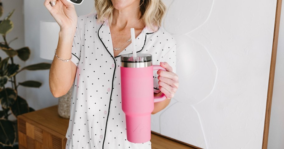 woman holding hot pink ozark trail 40oz tumbler