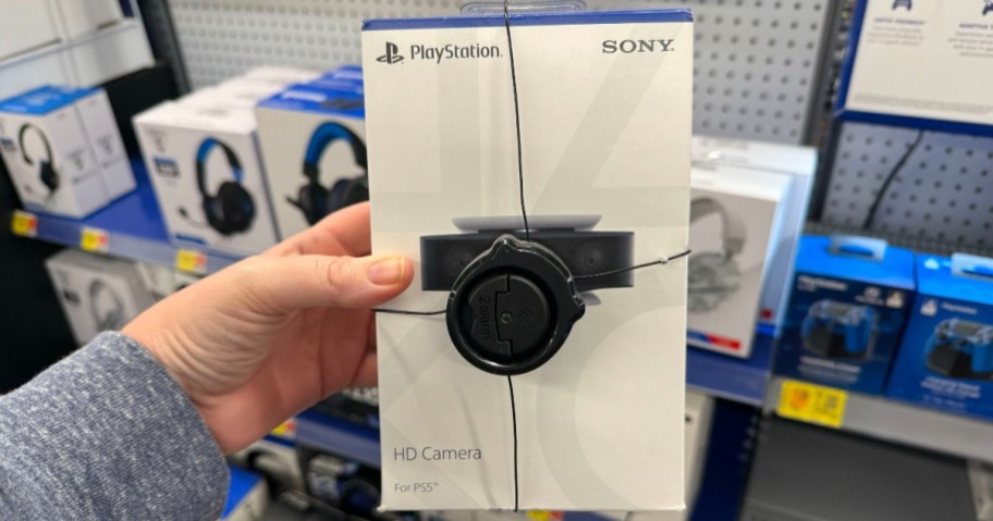 hand holding a Playstation 5 HD camera in box