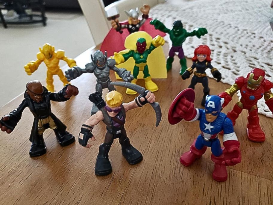 Several Playskool Marvel Heroes figures on a table