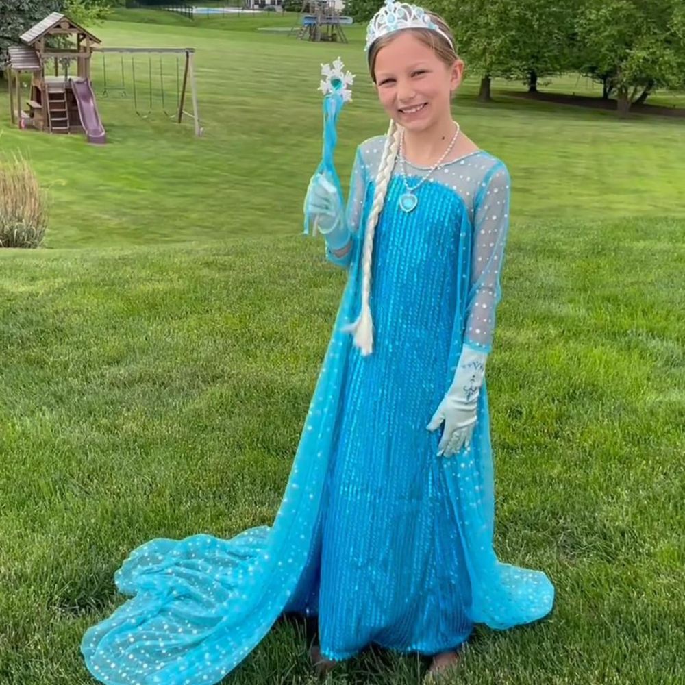 A girl wearing a Princess Elsa Costume with tiara