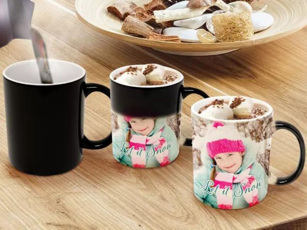 A Printerpix Magic Photo Mug in various stages of revealing the photo by adding hot water