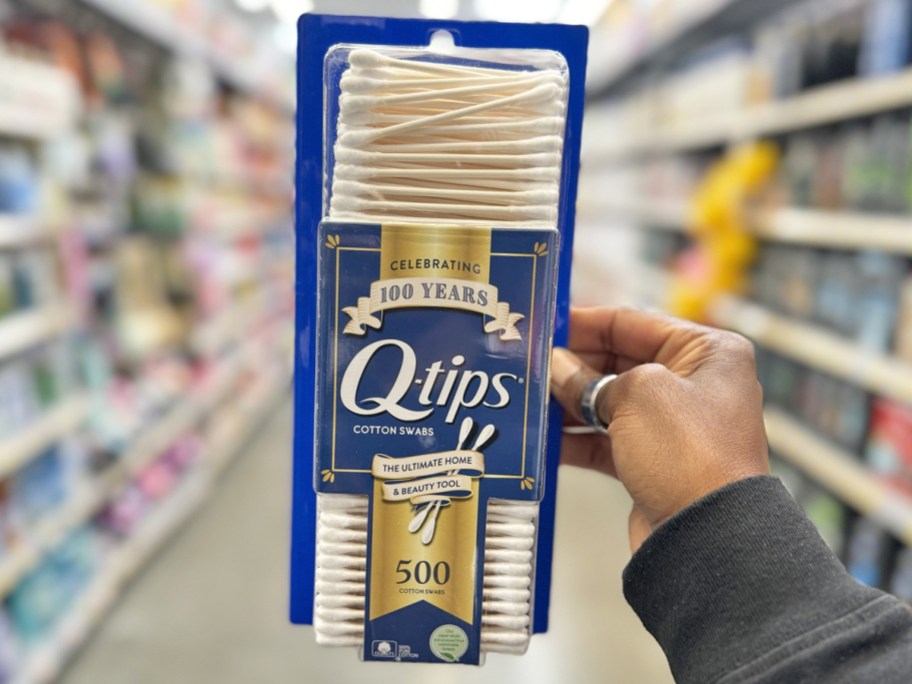 hand holding up a 500-count box of q-tips in store