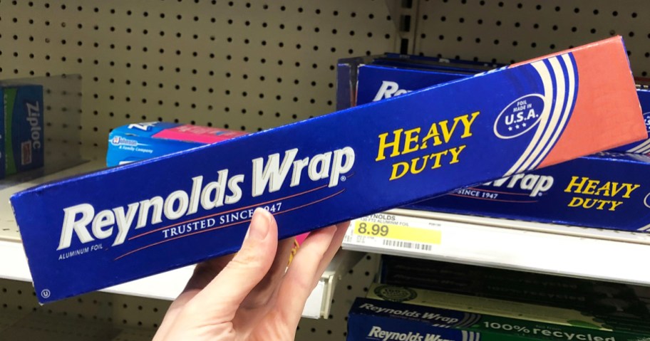 hand holding up a blue and pink box of Reynolds Wrap Heavy Duty Aluminum Foil