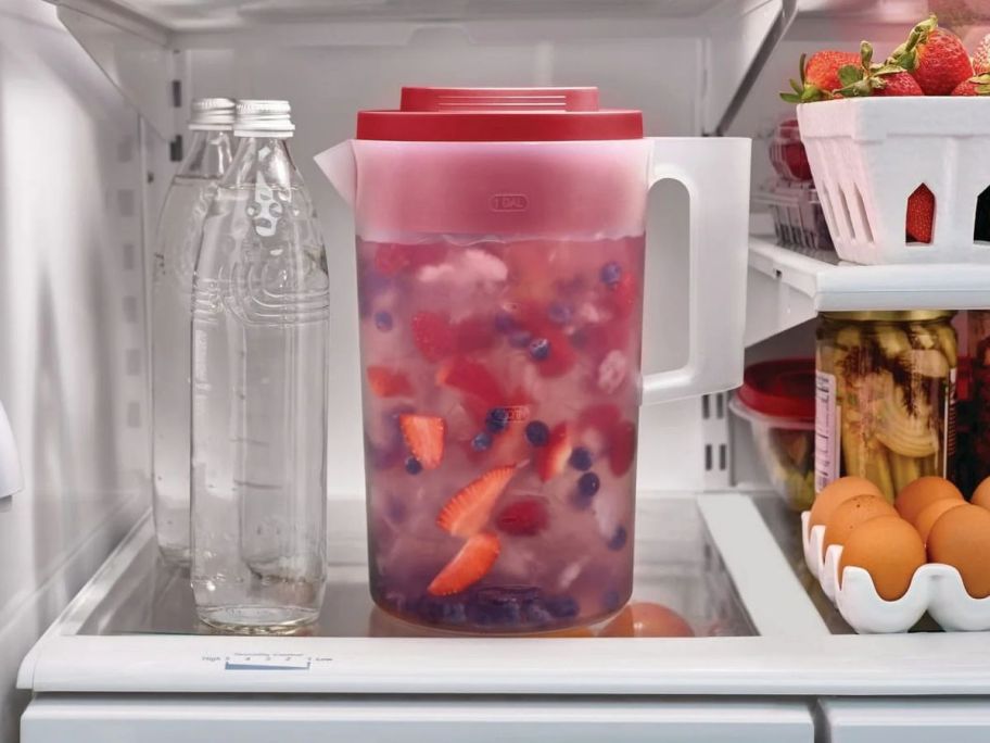 A large 1-Gallon Rubbermaid Pitcher filled with Sangria inside a fridge