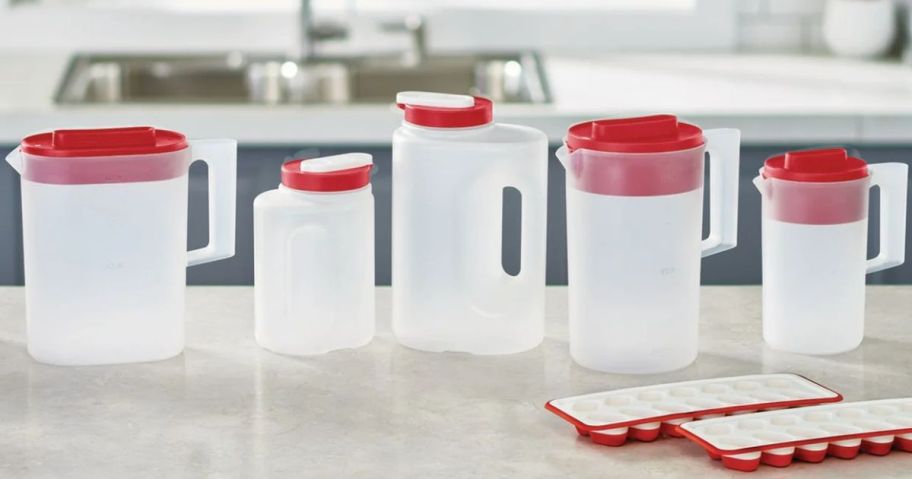 A counter with several Rubbermaid Plastic Pitchers on it