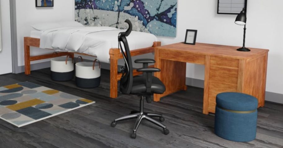 black ergonomic chair in bedroom by wooden desk