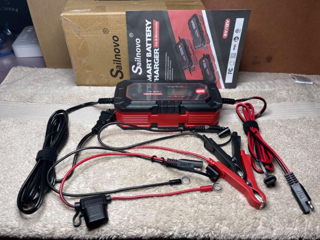 10A 6V/12V Battery charger shown with included accessories and instruction book