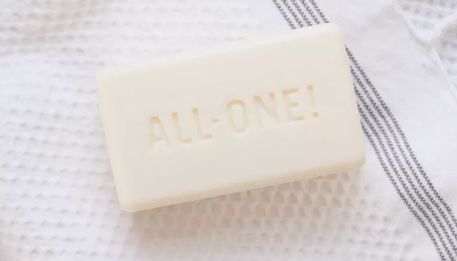 all one naked bar of soap on white towel