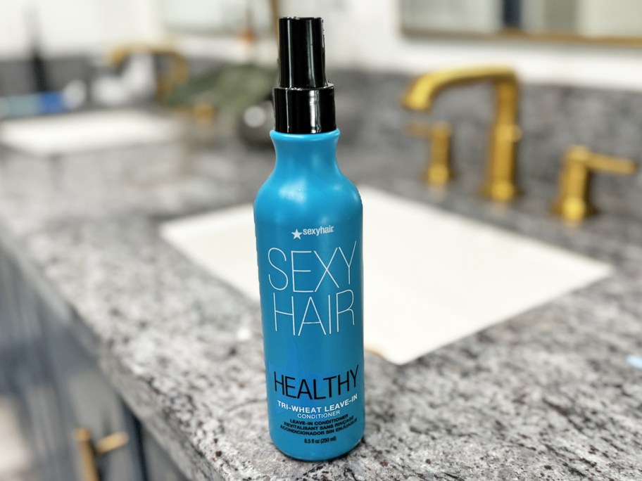 blue bottle of sexy hair leave-in conditioner on bathroom counter