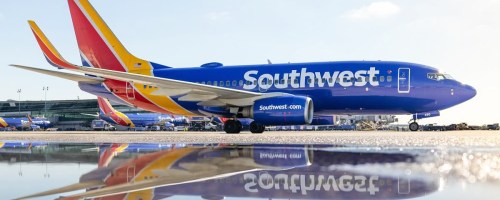 Southwest Airlines plane with reflection in puddle