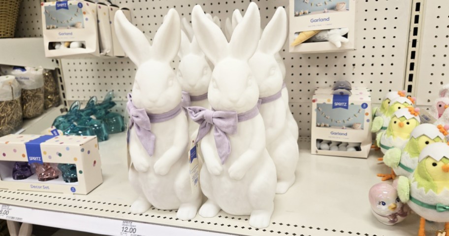 white bunny figurines with purple bows on store shelf