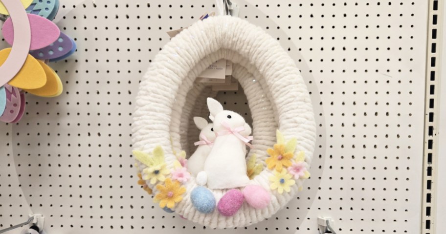 egg shaped wreath with a bunny inside on store display wall