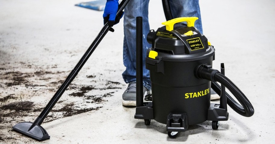 man using a stanley wet dry vac