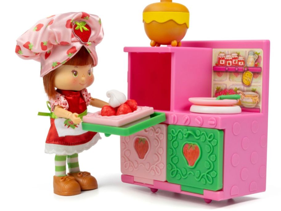 A Strawberry Shortcake doll with a baking set